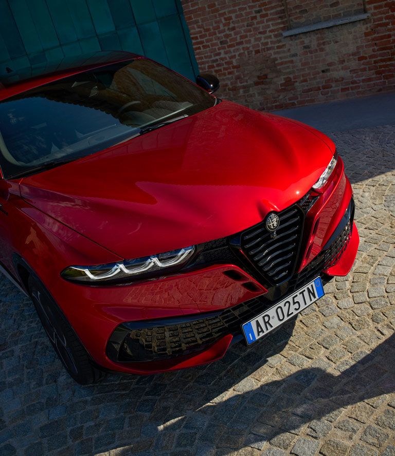Alfa Romeo Tonale in Misano Blu with Propulsion Engine Against Night Background​