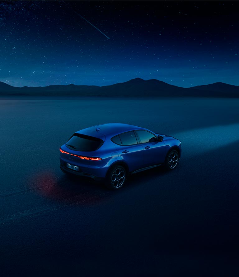 Alfa Romeo Tonale in Misano Blu with Propulsion Engine Against Night Background