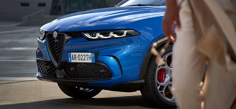 Alfa Romeo Tonale in Misano Blue Side Close Up with Person in Foreground 