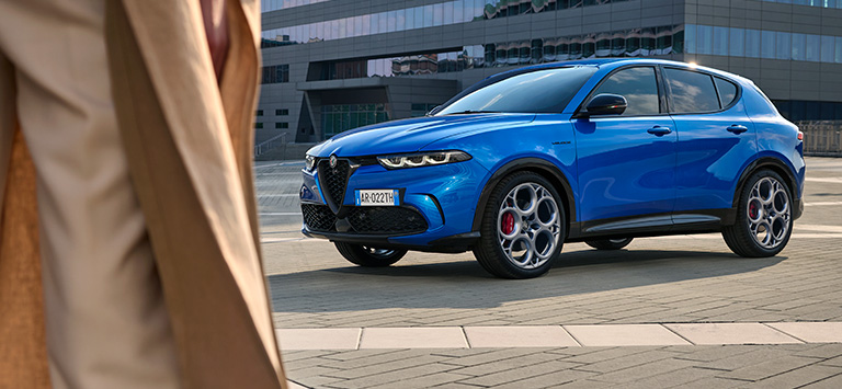 Alfa Romeo Tonale in Misano Blue Side View with Person in Foreground 