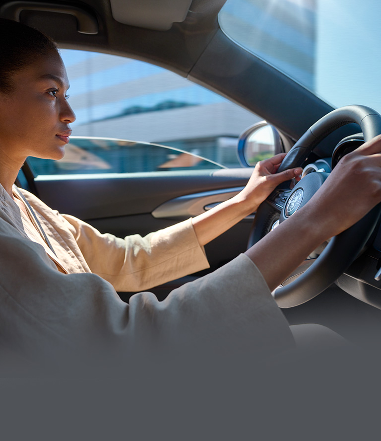 Woman Driving Alfa Romeo Tonale with Advanced Driver Assistance Systems